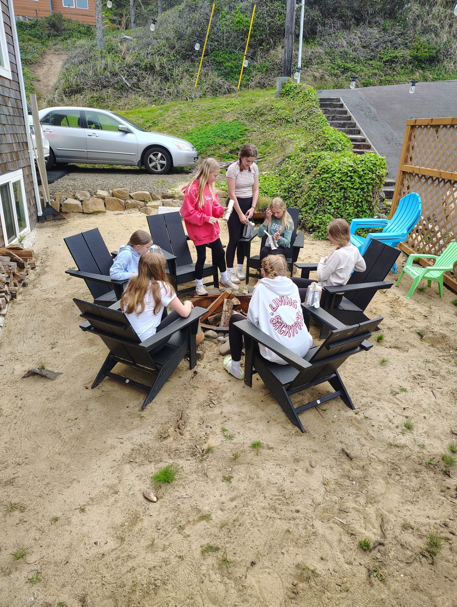 Guests gathered around the outdoor fire pit at Anchor Court Beach House Lincoln City Oregon vacation rental